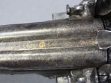 a close up of a gun that is on display