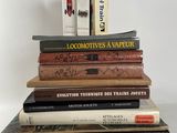 many books stacked on top of each other on a table