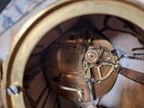 a close up of a person working on a clock