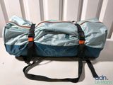 a duffel bag sitting on top of a white chair