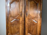 a wooden armoire with two doors on it