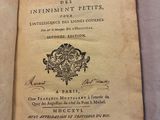 an old book with writing on it sitting on a table