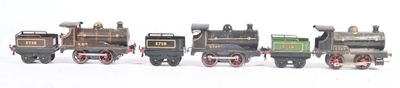 several toy trains are lined up in a row on a white surface