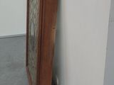 a tall wooden cabinet in the corner of a room