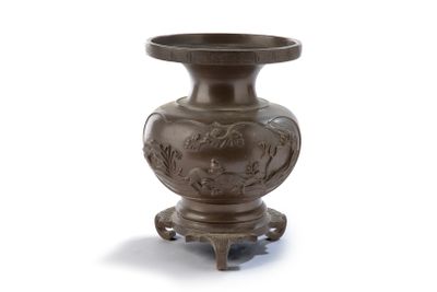 a brown vase that is on a stand on a white surface