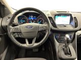 the interior of a car with a steering wheel, dashboard, and dashboard controls