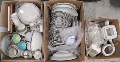 two boxes full of dishes and cups on the floor