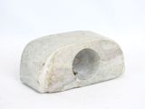 a small white rock with a hole in it