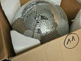a cardboard box with a mirror ball inside of it