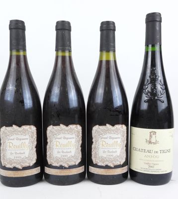 quatre bouteilles de vin sont alignées sur une table