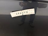 a man standing next to a car with a sticker on it