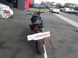a motorcycle parked in a parking lot with a sign on it