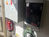 a fire extinguisor on the wall next to a fire hydrant