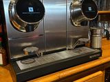 a coffee machine sitting on top of a wooden counter