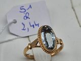 an image of a gold ring with a blue topaz stone