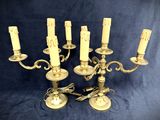 brass candelab with five candles on a blue background