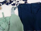 two pieces of clothing that are laying out on a bed