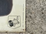 a sticker on the side of a skateboard on the ground