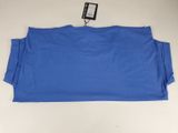 a close up of a blue t - shirt with a tag on it