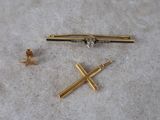 a small gold cross and a small gold cross on the floor