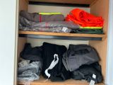 a closet full of clothes and other items that are on the shelves
