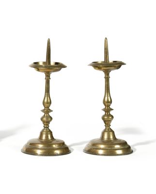 pair of antique brass candlesticks on a white background