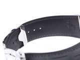 a close up of a watch on a white surface