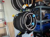 several tires are stacked on a shelf in a garage