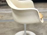 an image of a white chair sitting on top of a cement floor