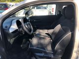 the interior of a small car with a steering wheel and a seat