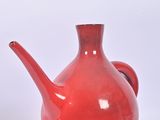 two red vases sitting next to each other on a white surface
