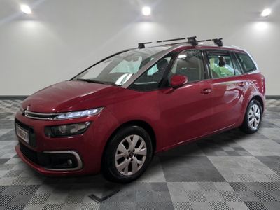 the red citrole is parked in a large room with a checkered floor