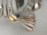 a lot of silver spoons and spoon spoons on the table