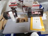 a table with a laptop, coffee cups, and other items on it
