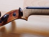 a close up of a violin on a wooden floor