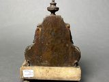 a small statue of a man sitting on top of a table