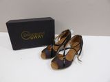 a pair of women ' s shoes in a box on a table