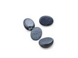 three black pebbles on a white surface with a white background