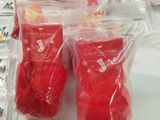 many bags of red heart shaped candies on a table