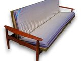 an image of a futon couch with a blue and white striped cover