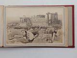 an old photo of a book with a picture of a city in the background