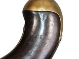a close up of a horn shaped object on a white surface