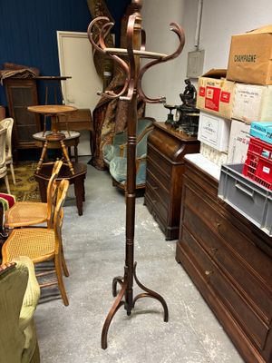 un porte-manteau dans une pièce où il y a beaucoup de meubles