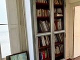 a book case with books on it in a room