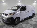 the white van is parked in a large room with a checkered floor