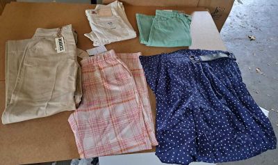 several pairs of shorts are laid out on a cardboard box