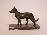 statue of a dog on a marble base on a white background
