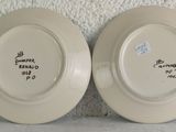 two white plates with writing on them on the wall