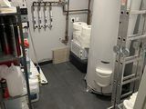 a room with a ladder, toilet, and other items in it