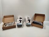 three boxes of nintendo wii controllers sitting on top of a white table
